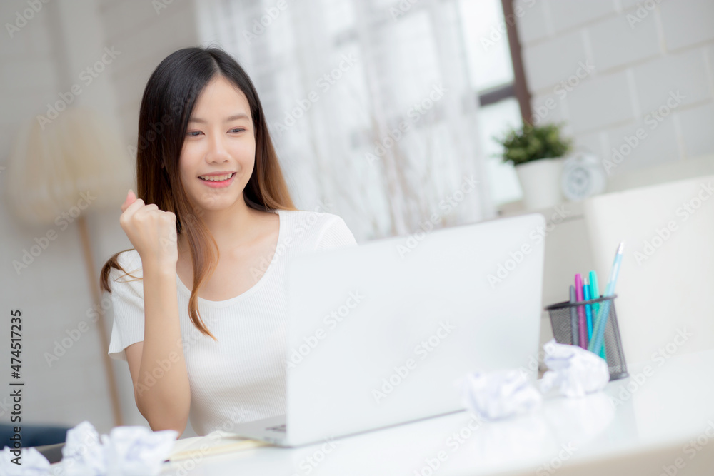 Young asian woman confident working at home with laptop computer and thinking idea for planning, freelance happy girl expression with excited and success using notebook thought, business concept. Young asian woman confident working at home with laptop computer and thinking idea for planning, freelance happy girl expression with excited and success using notebook thought, business concept.