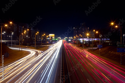 Light trails from fast moving cars at night. Large ring road with heavy traffic © Klochkov
