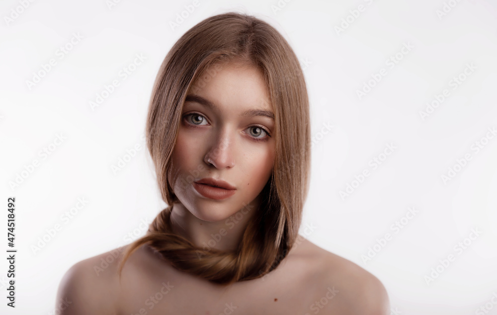 Cute and beautiful young woman with long hair wrapped around her neck on white background copy space. Care and health concept of the head and hair Cute and beautiful young woman with long hair wrapped around her neck on white background copy space. Care and health concept of the head and hair
