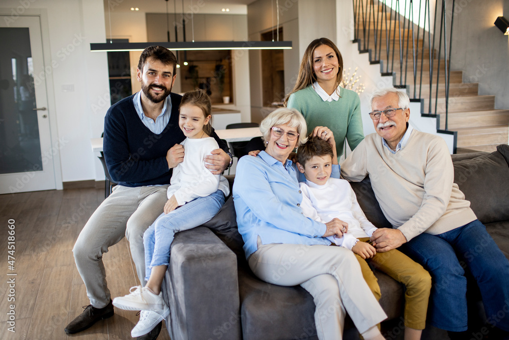 Multi generation family sitting together on the sofa at home Multi generation family sitting together on the sofa at home