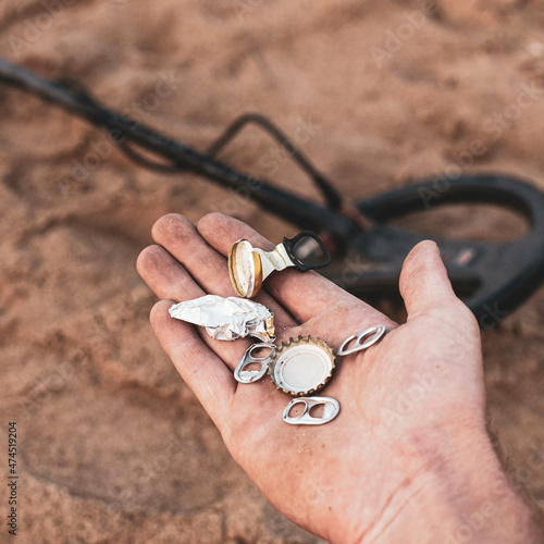 trash found on the beach with a metal detector, the problem of human pollution on the planet photo