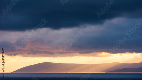 Sunlight and sea seeping through the clouds