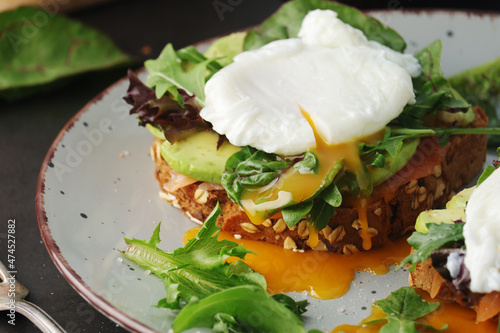 Homemade sandwiches with salmon, avocado and poached eggs