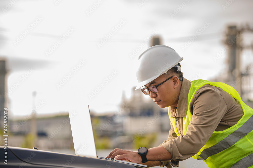 Asian man petrochemical engineer working at oil and gas refinery plant industry factory,The people worker man engineer work control at power plant energy industry manufacturing Asian man petrochemical engineer working at oil and gas refinery plant industry factory,The people worker man engineer work control at power plant energy industry manufacturing