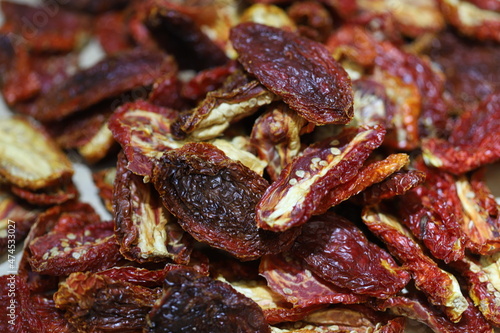 Sun dried tomatoes pile isolated on white background