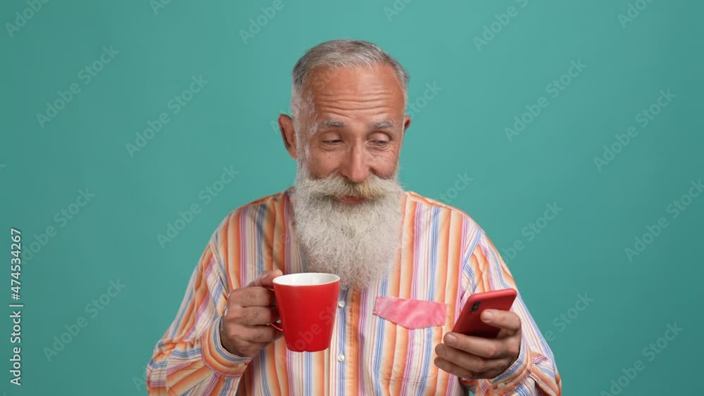 Aged man use device search sale drink beverage isolated cyan color background Aged man use device search sale drink beverage isolated cyan color background