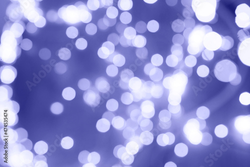 Defocused Very Peri colour tones abstract christmas background. Texture Bokeh. 2022 New year.