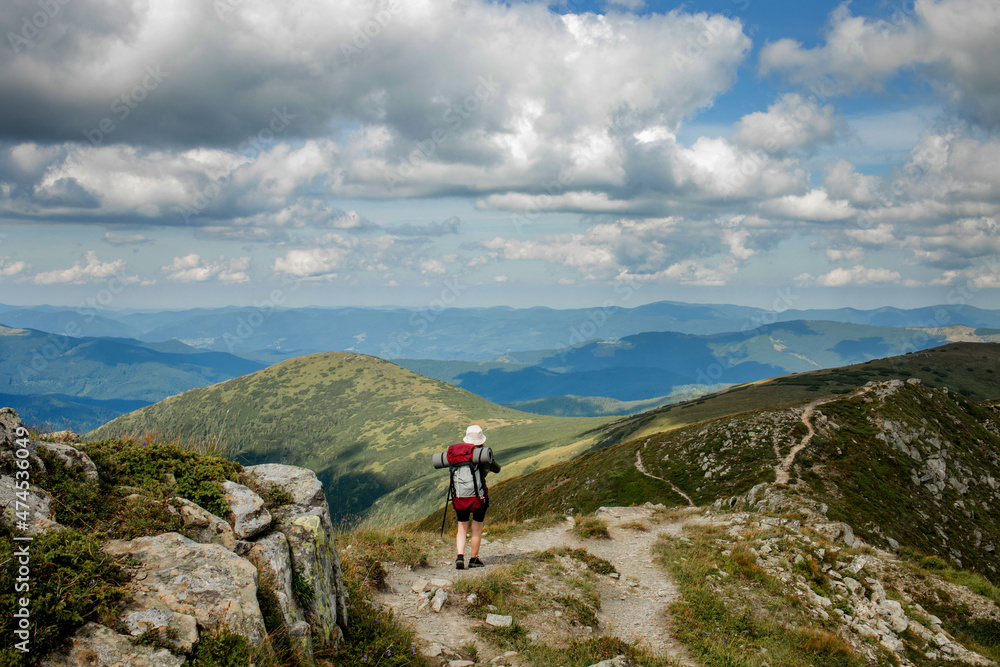 Hiker on the top in Carpathians mountains. Travel sport lifestyle concept.