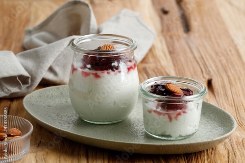 Danish Creamy Rice Pudding (Risalamande), Sweet Dessert Served with Warm Cherry Sauce for Christmas Dinner