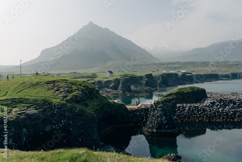 Field with a village at the base of Gatklettur Volcanic peak. photo