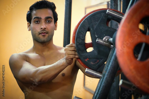 Young Indian men in gym going for do heavy workout