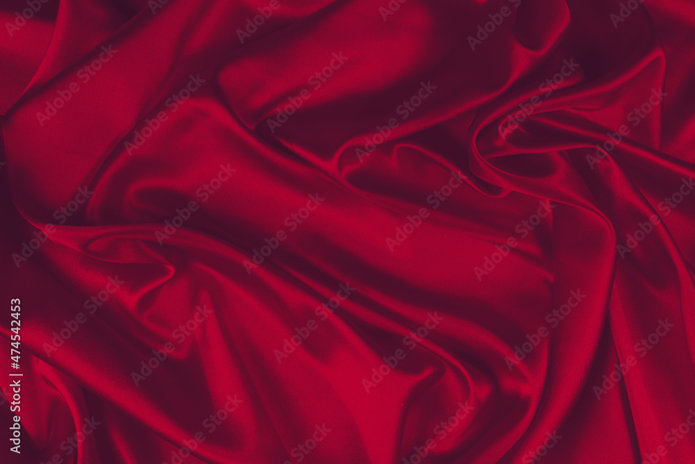 Red silk or satin luxury fabric texture can use as abstract background. Top view. Red silk or satin luxury fabric texture can use as abstract background. Top view.