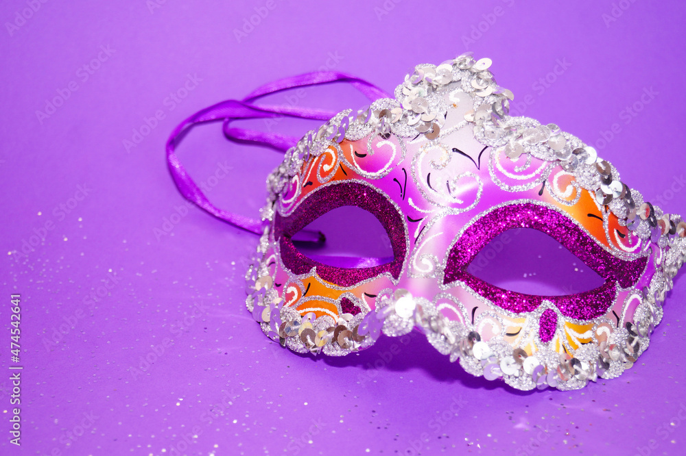 Purple-yellow carnival mask on a purple background. Purple-yellow carnival mask on a purple background.