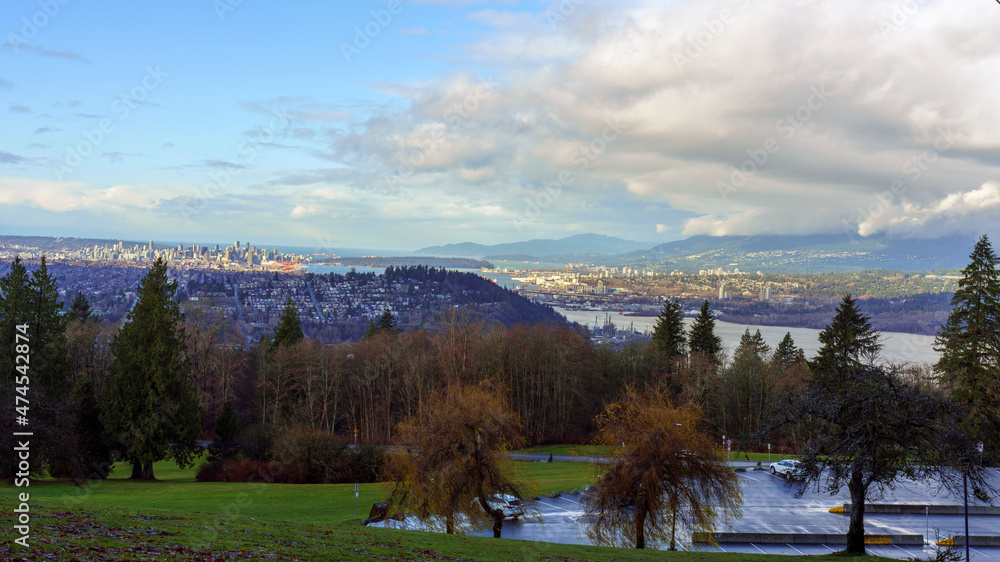 Obraz premium Car park shortly after rain at Burnaby Mountain Park with view down Burrard Inlet downtown Vancouver, Stanley Park and Stratis of Georgia.
