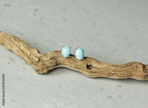 Stud earrings made of natural larimar. Designer earrings from natural larimar stones. Women's jewelry on a light background and stone. Author's modern jewelry. Larimar jewelry earrings studs photo