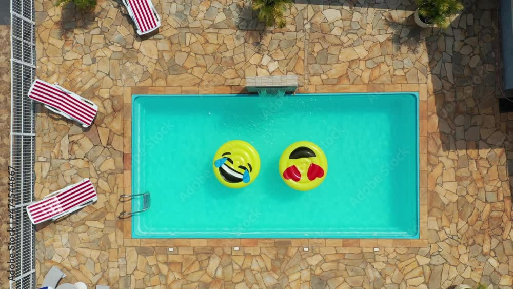 Top view of smile emoji float at swimming pool. Float smile emoji