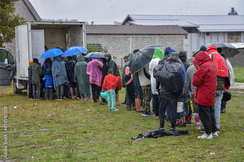 Refugees and migrants are waiting for food distributed to them by local volunteers in Velika Kladusa, Bosnia and Herzegovina. People from Africa and Asia stand in line in the rain and wait for food in