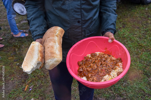 The man shows food he received from local volunteers in Velika Kladusa, Bosnia and Herzegovina. Migrants and refugees receive food from the local population. photo