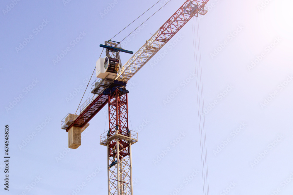 Tower crane on a blue sky background