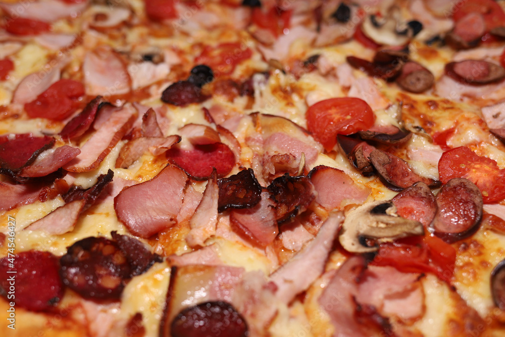 Pizza with cheese, ham and tomatoes close-up Pizza with cheese, ham and tomatoes close-up