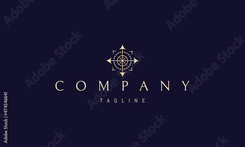 Vector golden logo with an abstract image of a compass that also looks like the sun.