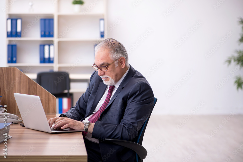 Old male employee and too much work in the office Old male employee and too much work in the office