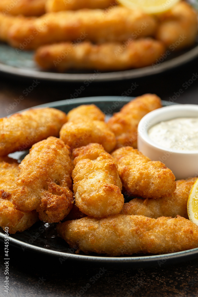 Crispy Fish strips with tartar sauce in a plate Crispy Fish strips with tartar sauce in a plate