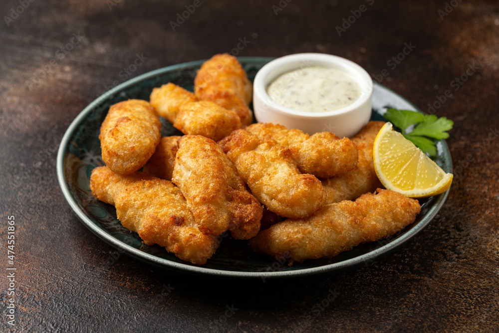 Crispy Fish strips with tartar sauce in a plate Crispy Fish strips with tartar sauce in a plate