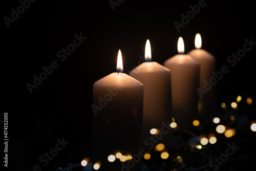 Fourth advent  four candles - candlelight on dark brown panorama background - advent banner. Horizontal banner for homepage. Template for greeting cards  funeral cards and obituaries.