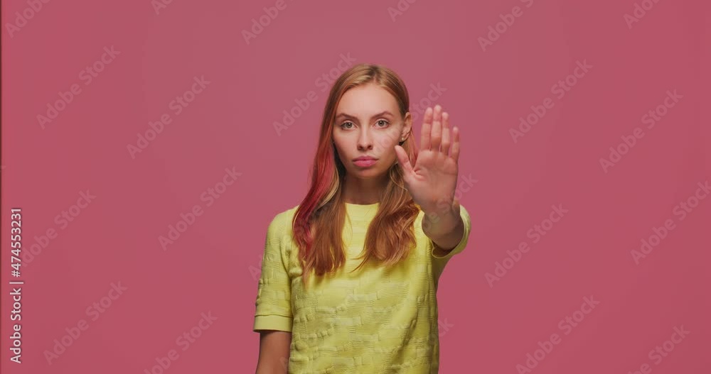 Serious young girl show stop gesture outstretched hand. Anti domestic violence, discrimination, fight for women rights Serious young girl show stop gesture outstretched hand. Anti domestic violence, discrimination, fight for women rights