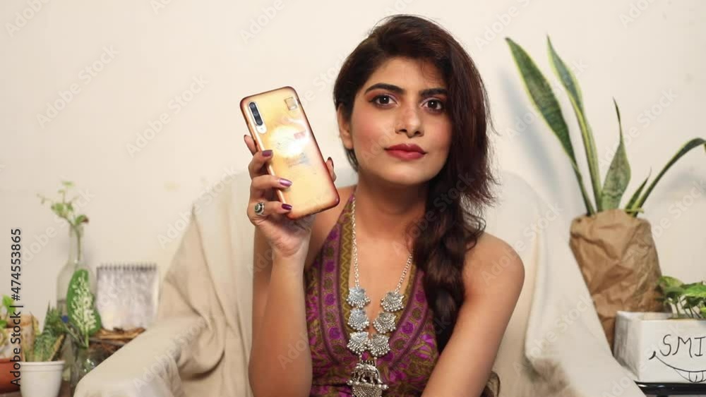 Mumbai, India - September 12 2021 : Beautiful Indian Lady in Bikini Blouse with jewellery taking selfie and showing the cell phone Mumbai, India - September 12 2021 : Beautiful Indian Lady in Bikini Blouse with jewellery taking selfie and showing the cell phone