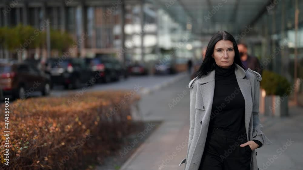 confident and serious woman is walking in business district in downtown, wealthy and rich lady confident and serious woman is walking in business district in downtown, wealthy and rich lady