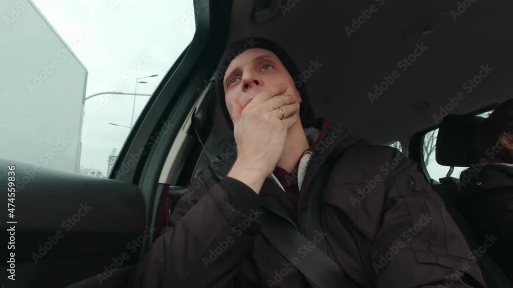 Man passenger rides in a car slow motion with wife driving Man passenger rides in a car slow motion with wife driving