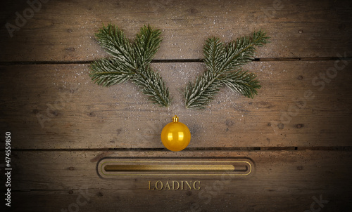 Antlers deer or roebuck made of fir branch with nose made of golden Christmas tree ball with loading beam. Loading merry Christmas and a happy new year 2025.