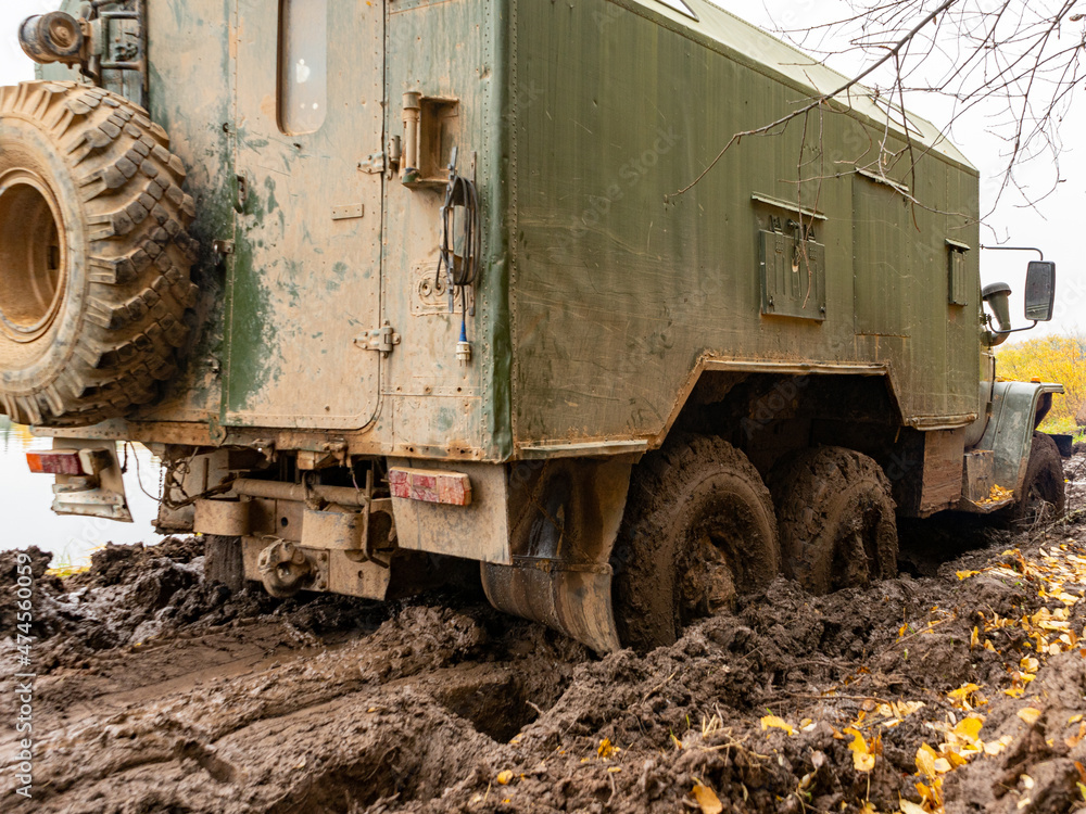 The truck got stuck on a dirty, broken forest road. Autumn thaw. Off - road The truck got stuck on a dirty, broken forest road. Autumn thaw. Off - road