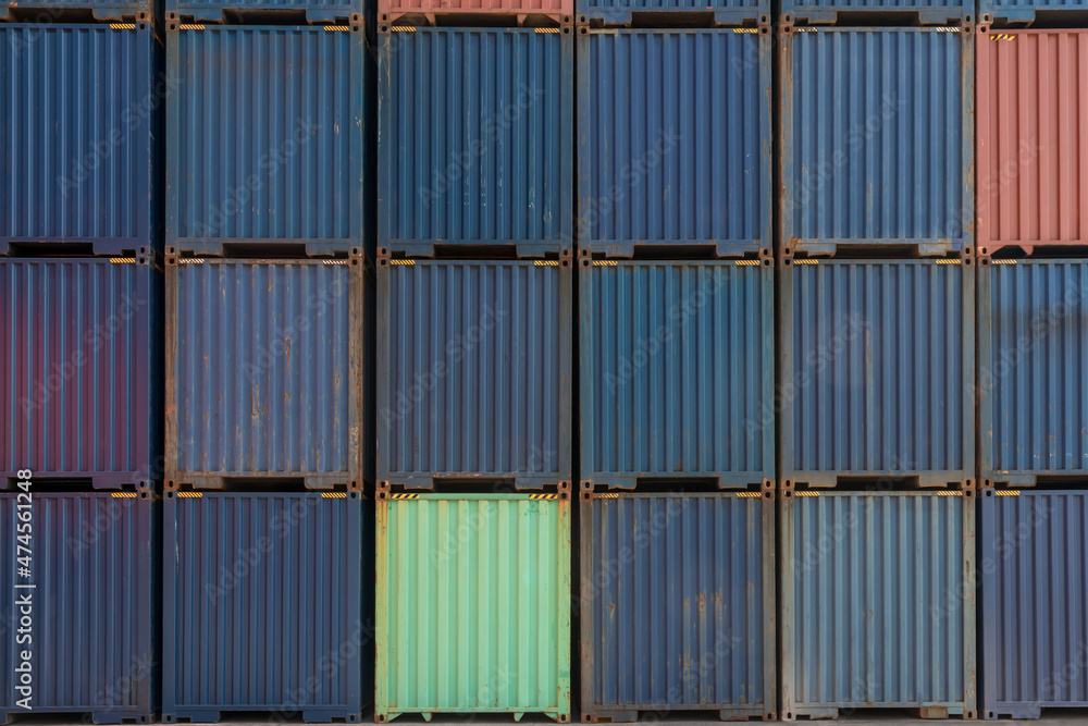 Stack of containers in a harbor. Shipping containers stacked on cargo ship. Background of Stack of Containers at a Port. Stack of containers in a harbor. Shipping containers stacked on cargo ship. Background of Stack of Containers at a Port.