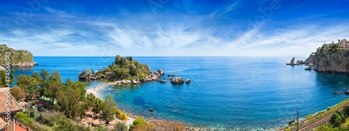 Isola Bella, small island near Taormina surrounded by azure waters of Ionian Sea, Sicily, Italy. Narrow path connects island to mainland Taormina beach.