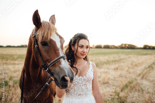 bride in a white dress next to a brown horse