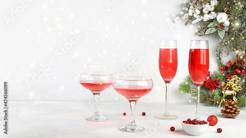 Christmas alcoholic or non-alcoholic cocktail with cranberry and cinnamon spice, red mimosa cocktail with champagne, warming winter drink in the cold season, christmas festive grog,