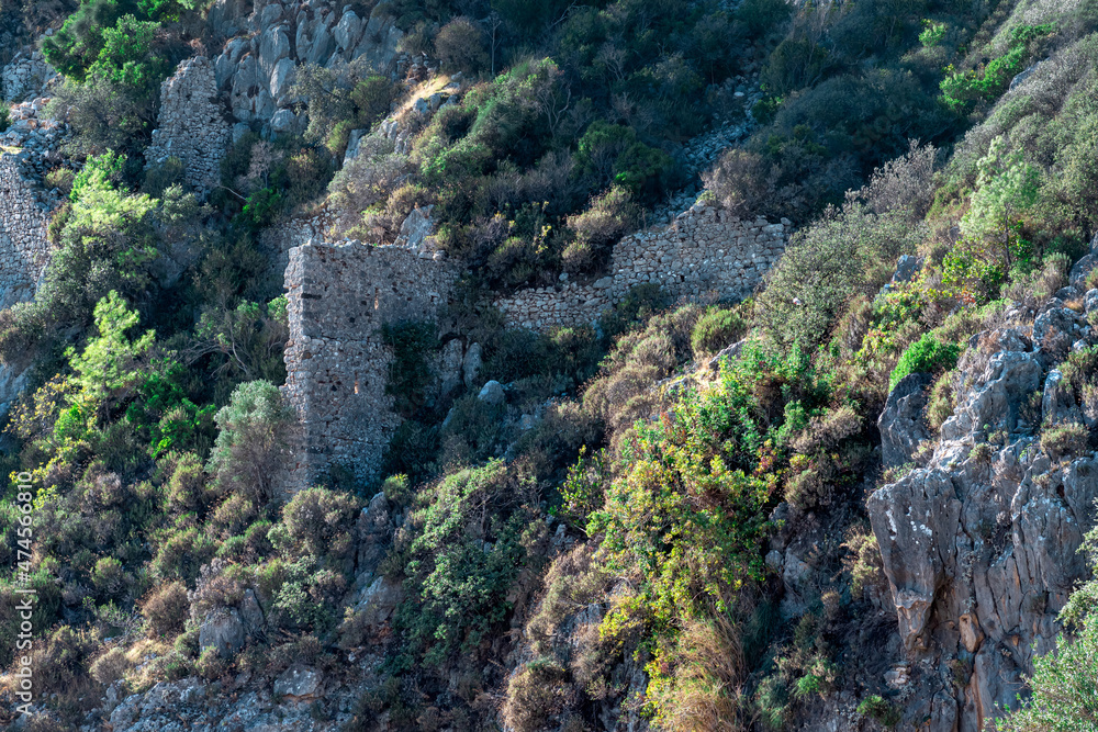 ruins of fortress walls on rocky mountain slopes near the ancient city of Olympus, Turkey