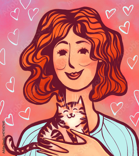 red-haired woman or girl with a tabby kitten in her arms.