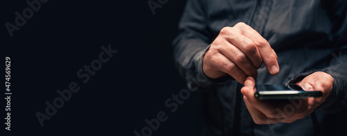Panoramic closeup of male hands using smartphone for text message communication