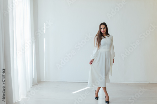 beautiful woman in a light summer dress on a white background