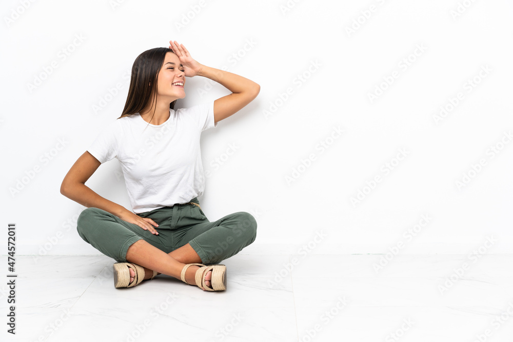 Teenager girl sitting on the floor has realized something and intending the solution Teenager girl sitting on the floor has realized something and intending the solution