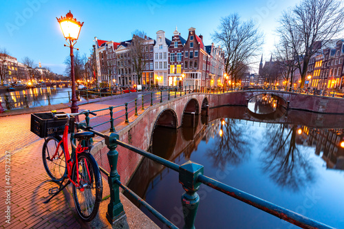 Amsterdam canal Keizersgracht with typical dutch houses and bridge during morning blue hour, Holland, Netherlands