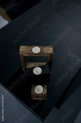 elegant candles on a wooden stand © jozzeppe777
