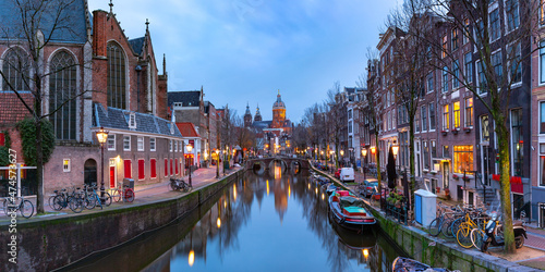 Panorama of canal in De Wallen, famous red-light district in the twilight, Amsterdam, Holland, Netherlands.