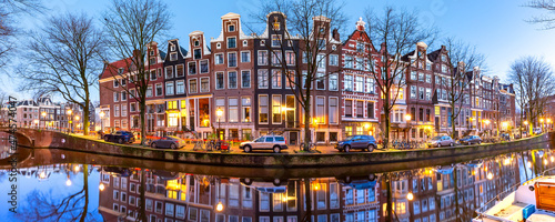 Panorama of Amsterdam canal Leidsegracht with typical dutch houses during morning blue hour, Holland, Netherlands.