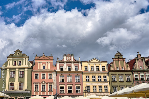 facades of historic tenements houses and umbrellas of the restauranton the Old Market Square in Poznan 