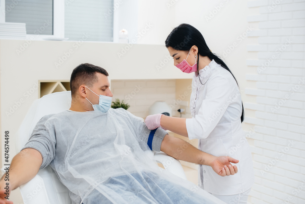 A man's blood is taken from a vein for analysis and testing for viruses. The formation of the immune system and antibodies. A man's blood is taken from a vein for analysis and testing for viruses. The formation of the immune system and antibodies.